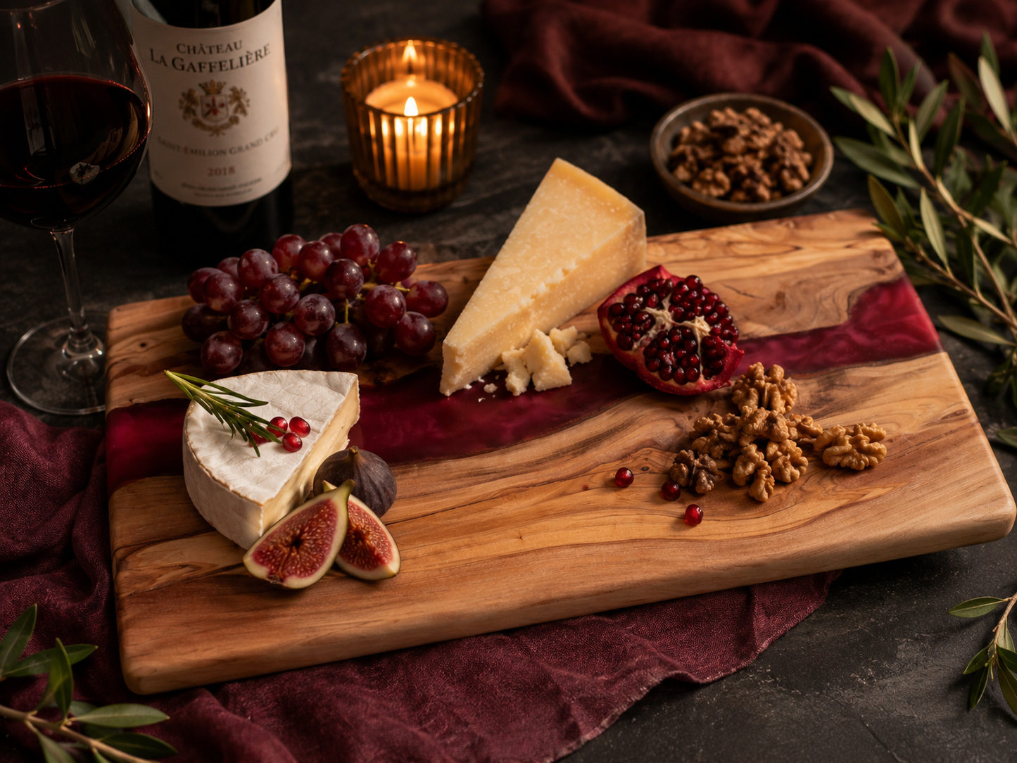 Wooden platter with assorted cheeses, fruits, and nuts on a dark surface with a candle and wine bottle in the background.